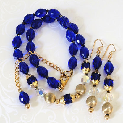 Cobalt blue glass beaded necklace and earrings set, with gold tone accents.