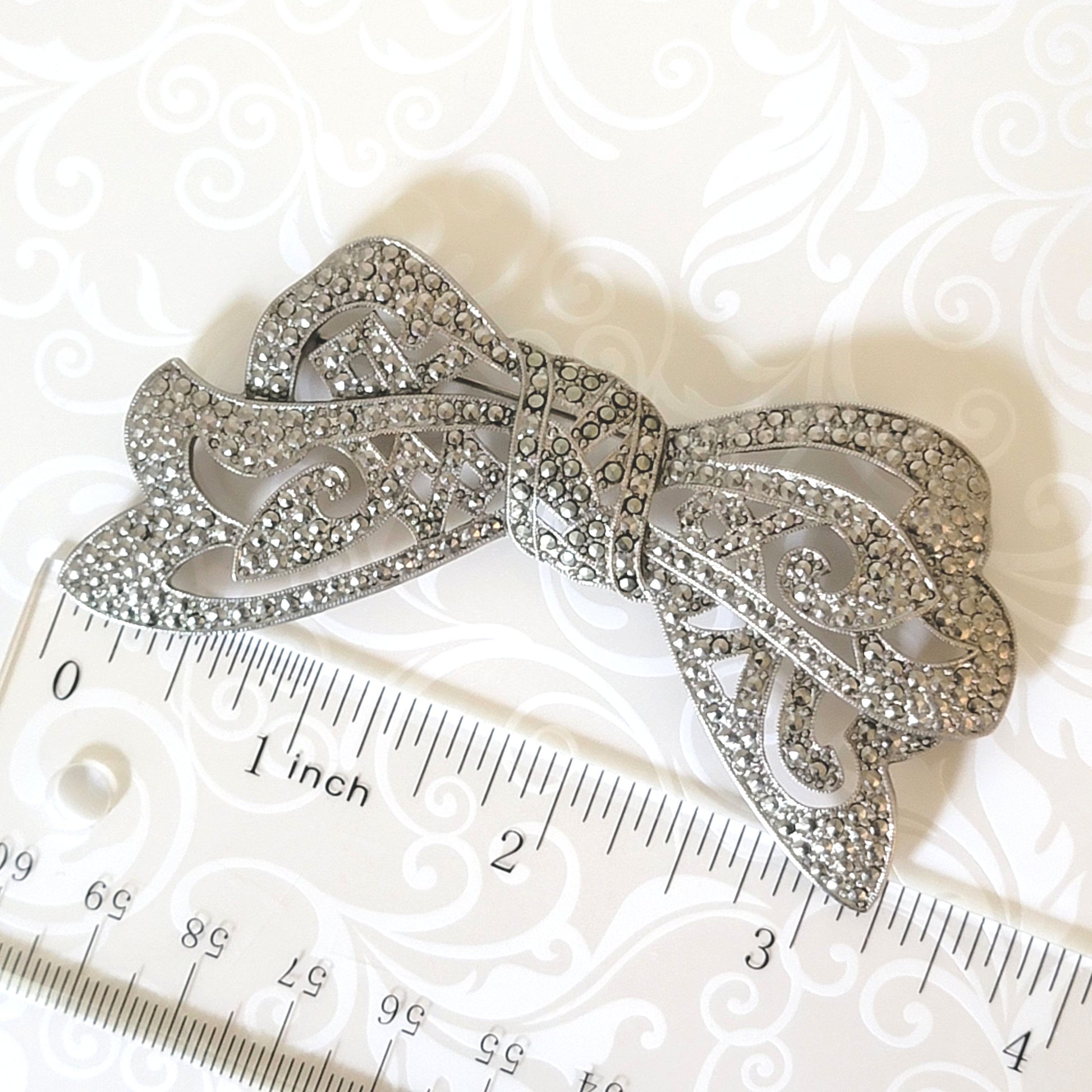 Vintage 1928 bow brooch with ruler.