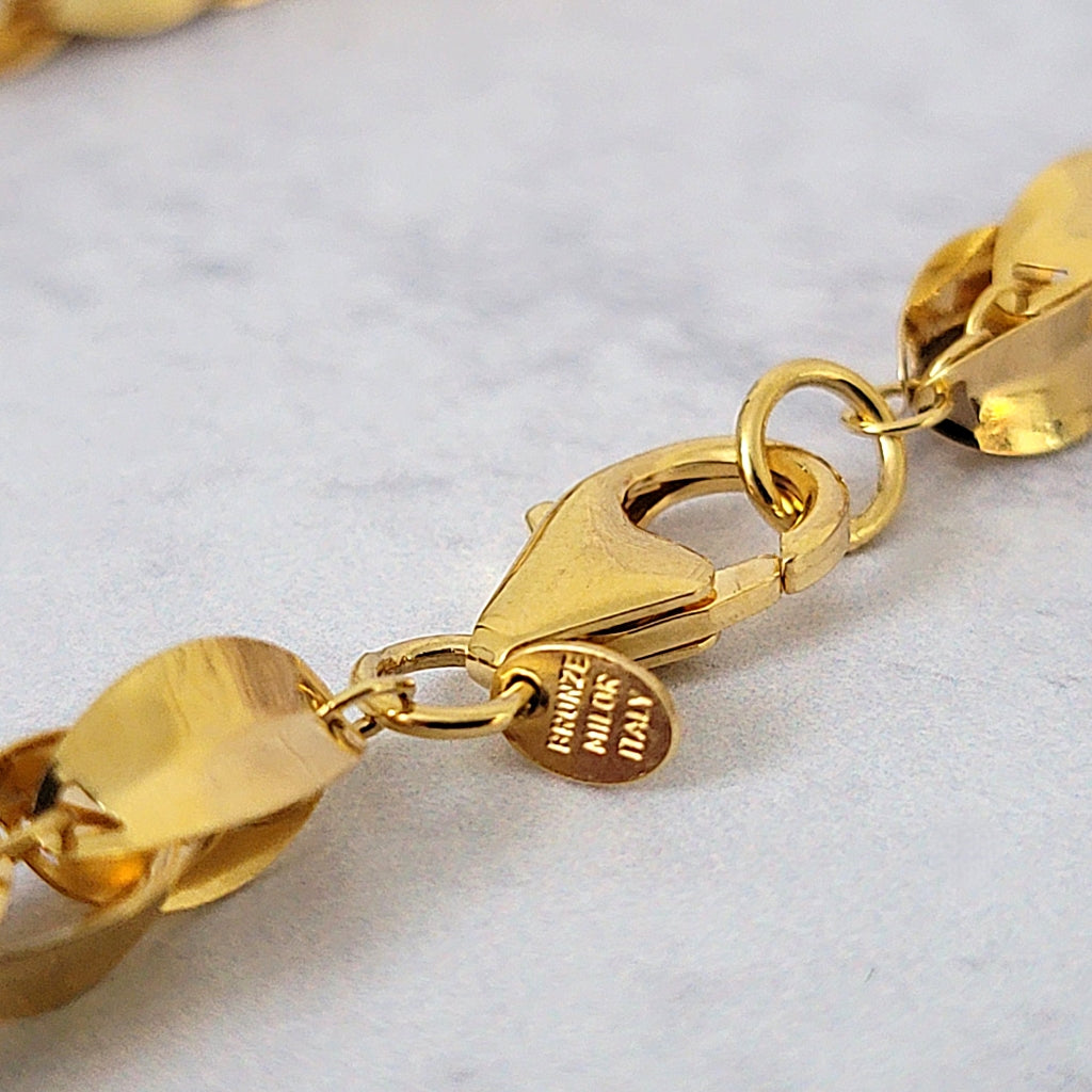 Bronze Milor Italy tag on a necklace.