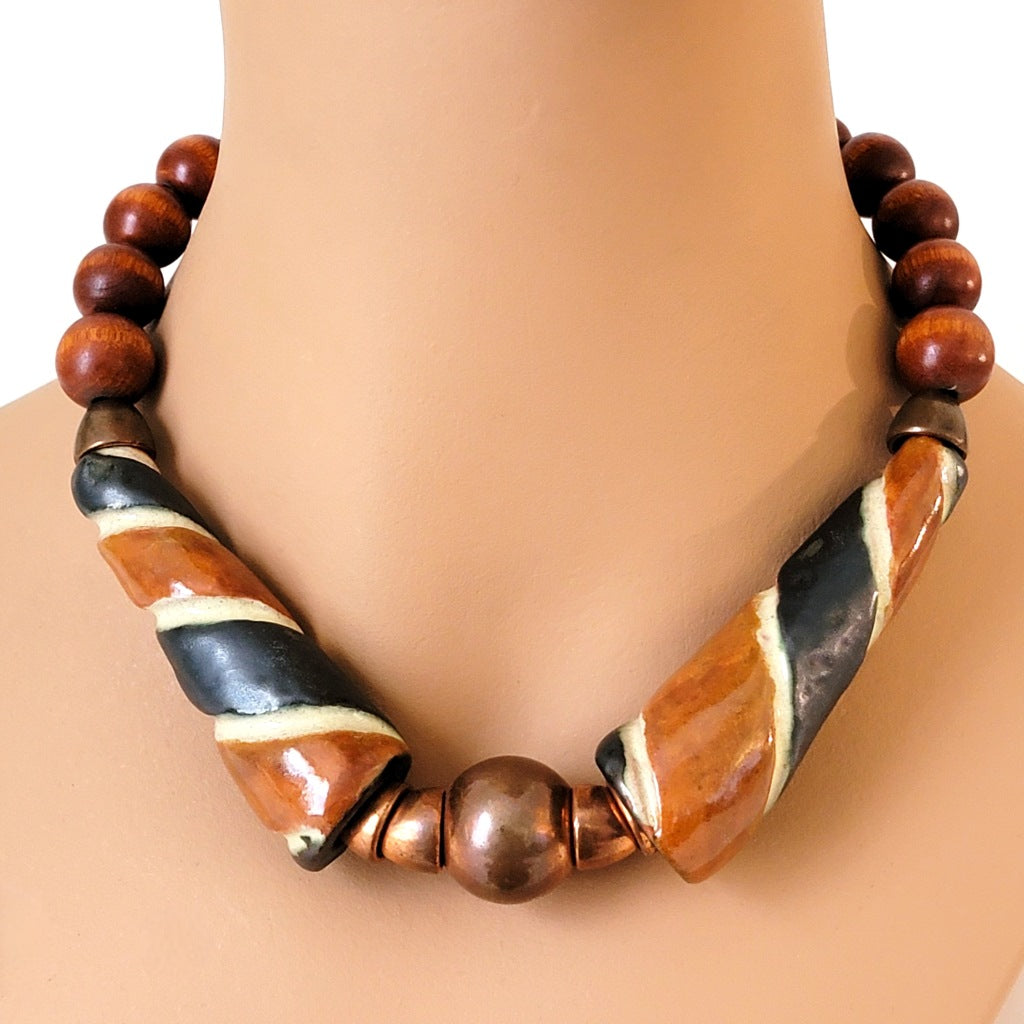 Chunky brown wood and ceramic beaded choker on display.