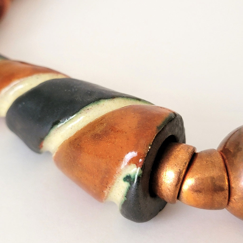 Striped ceramic bead.
