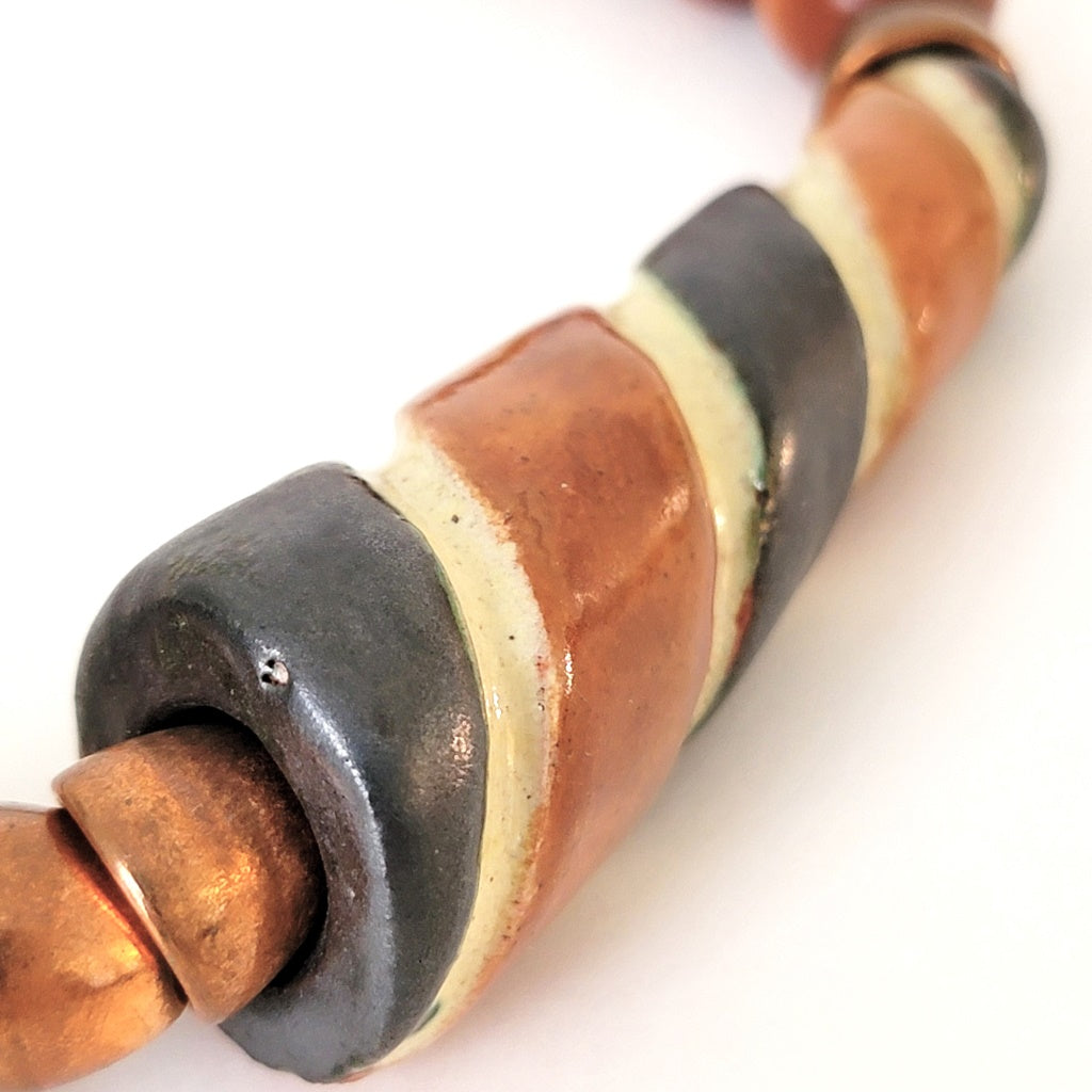 Striped ceramic bead.