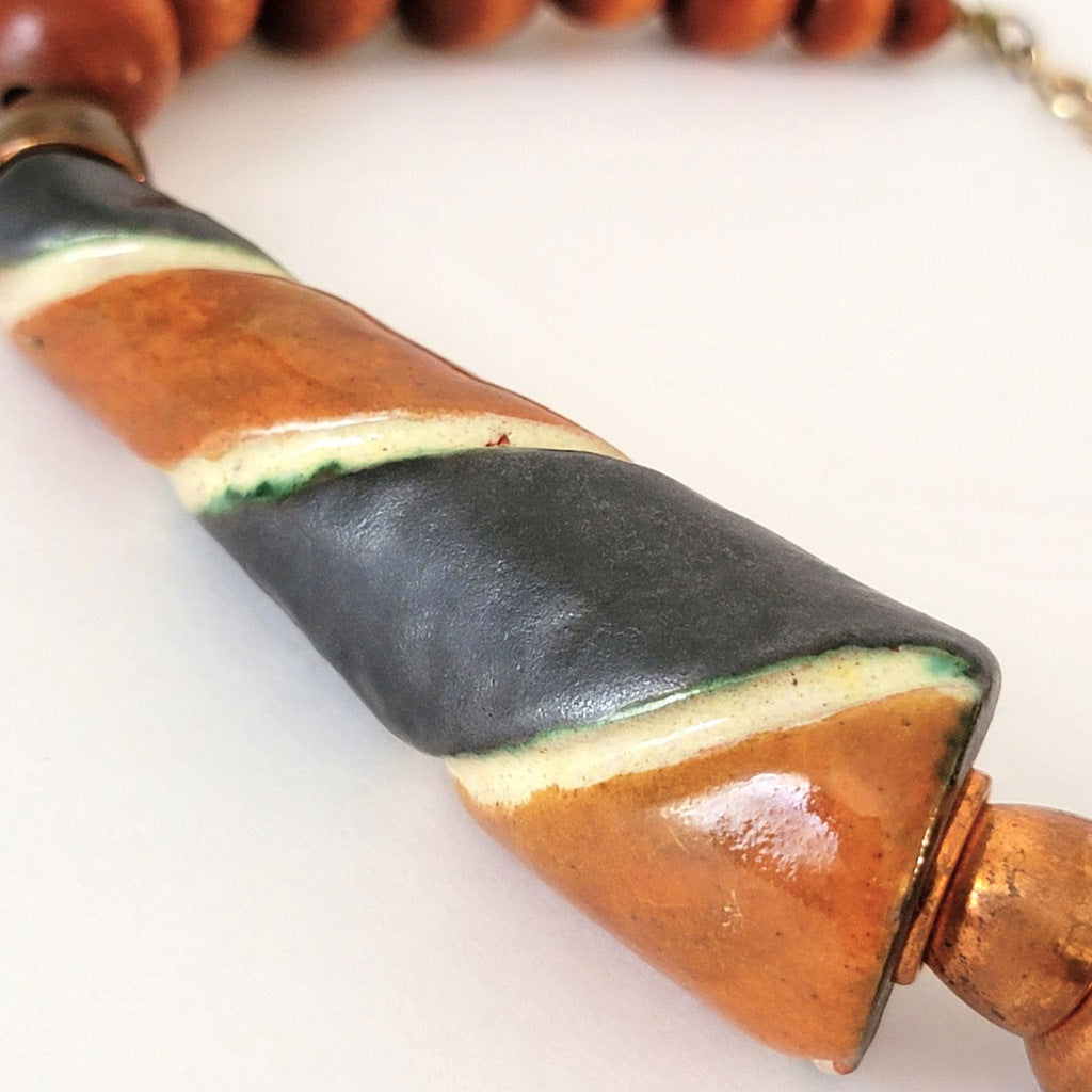 Large striped ceramic bead.
