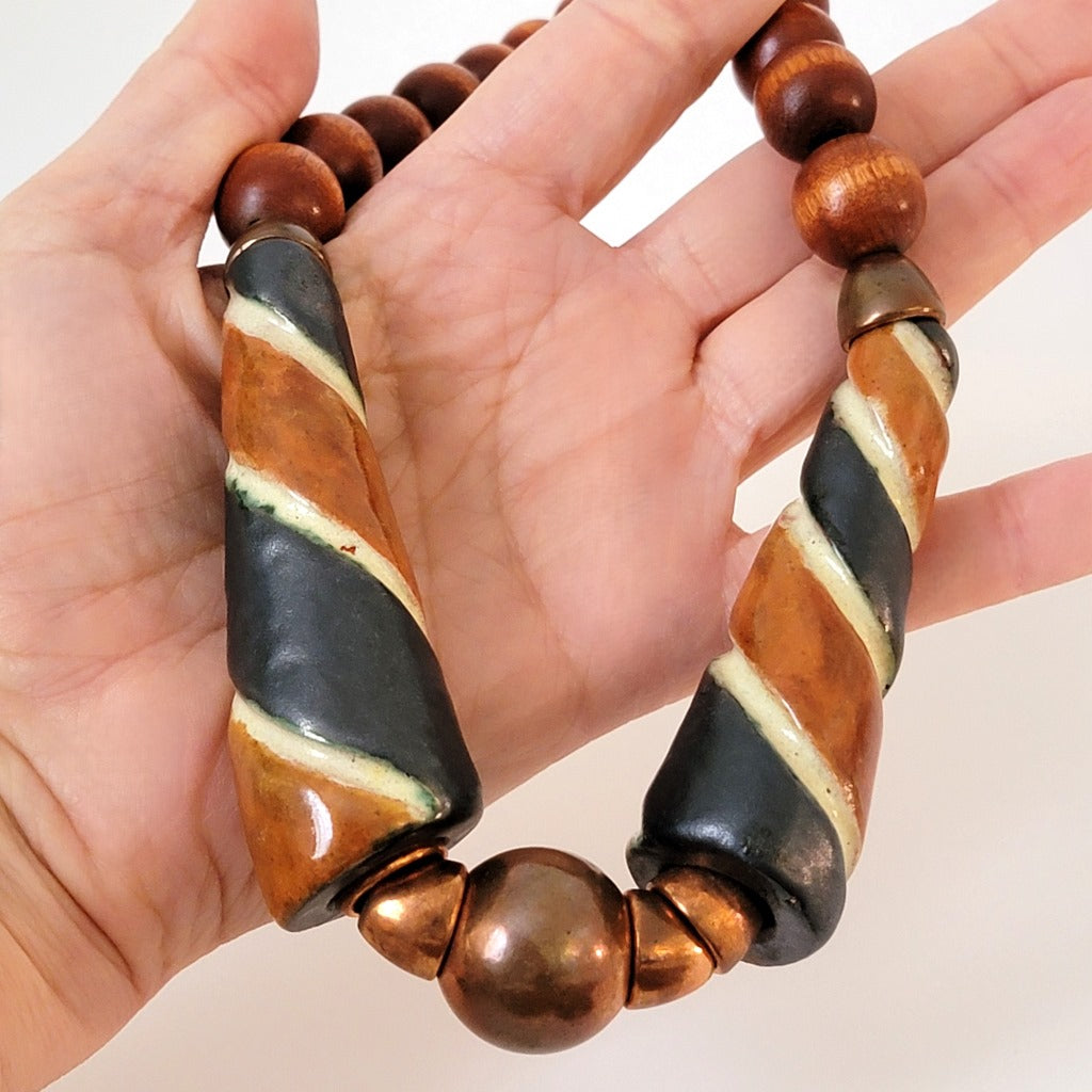 Chunky beaded choker in hand.