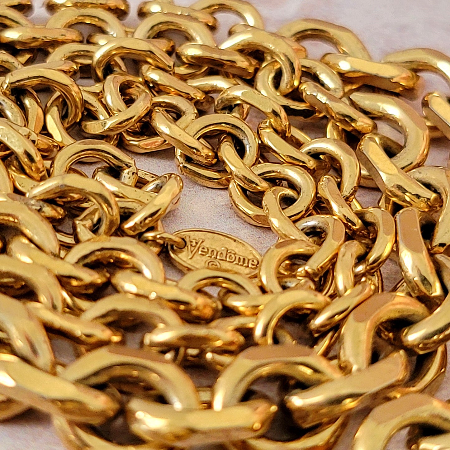 Vendome tag on a gold tone chain.