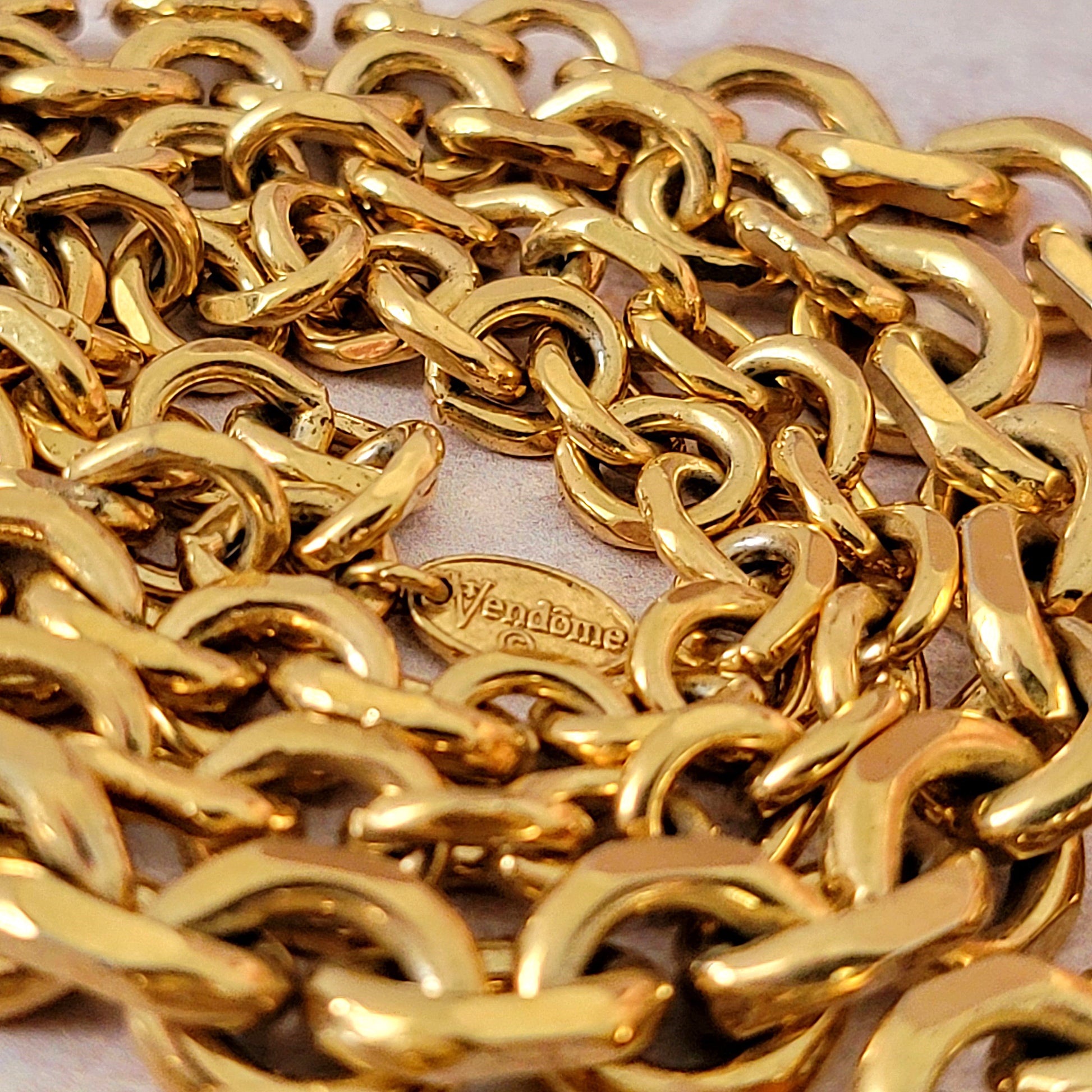 Vendome tag on a gold tone chain.