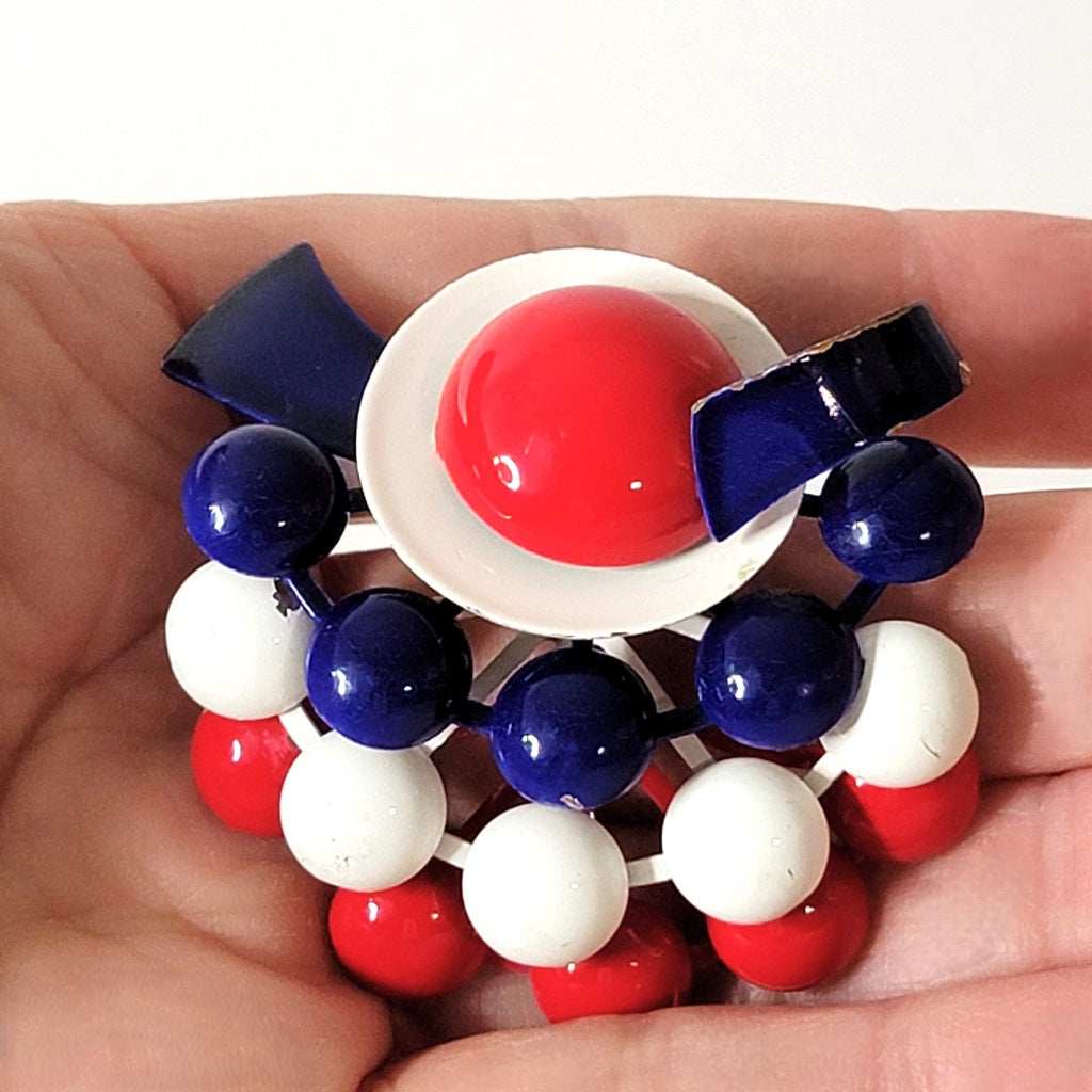 Vintage patriotic pin in hand.