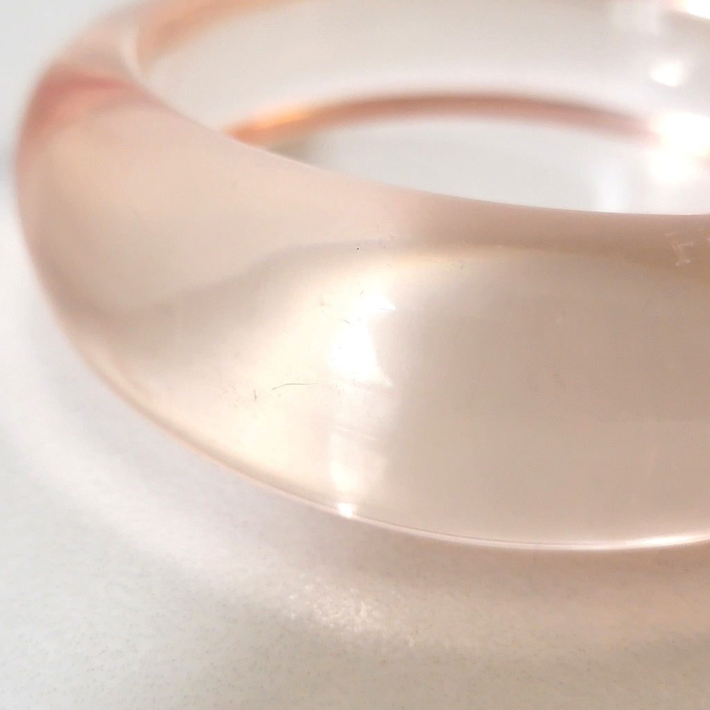 Close up of clear plastic bracelet.