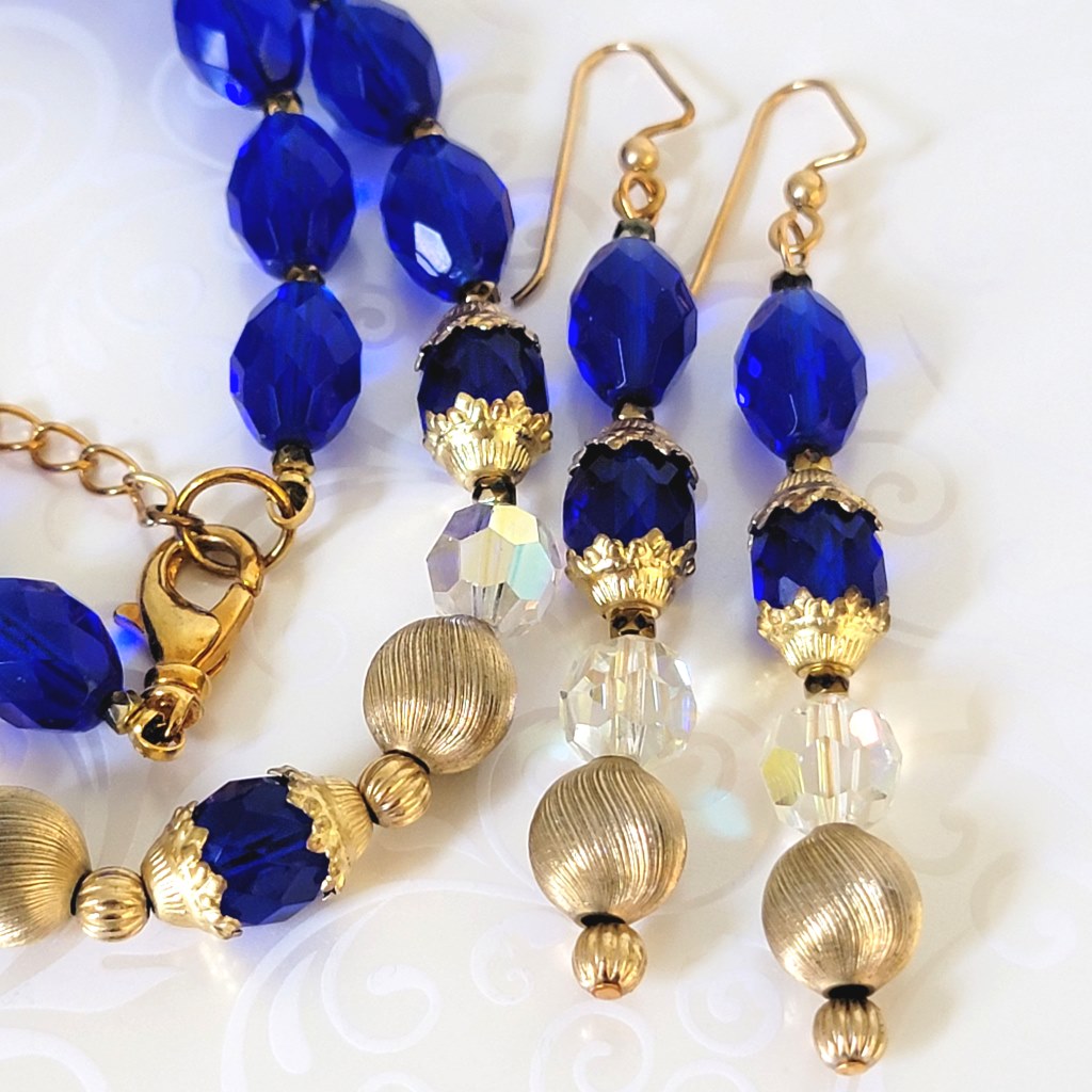 Close-up view of blue glass beads, on handmade long dangling earrings.