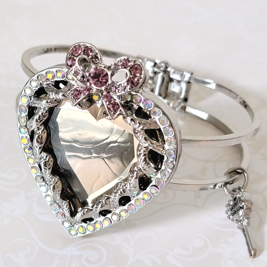 Closeup view of a Betsey Johnson mirror heart bracelet.