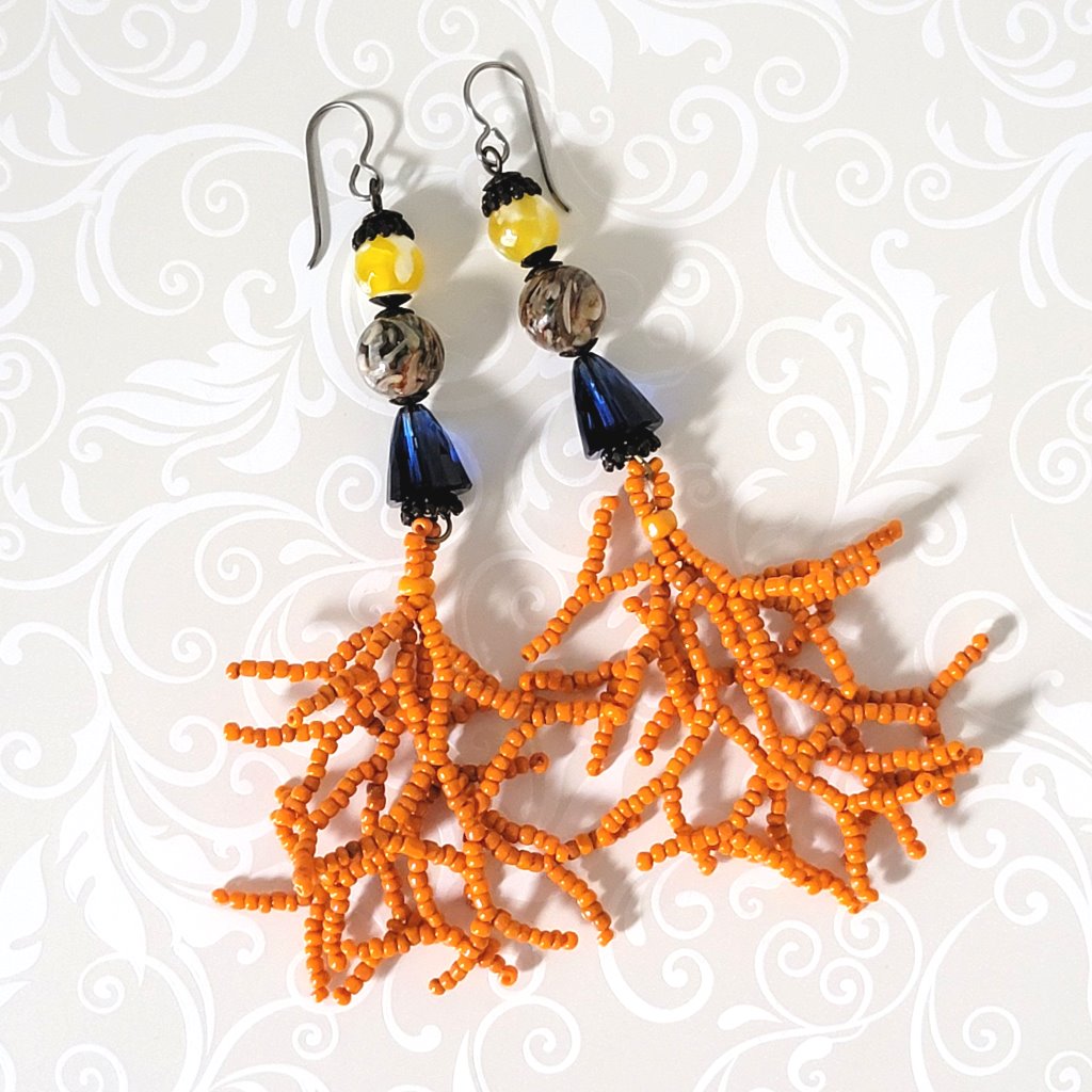 Long boho style dangle earrings with yellow stones, blue crystals and coral seed bead branches.