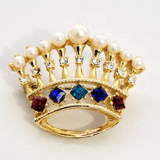Crown brooch with faux pearls.
