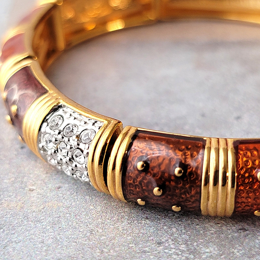 Brown enamel and clear rhinestones on a bracelet.