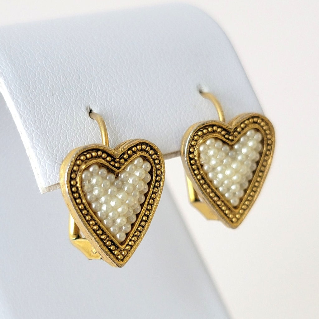 Side view, heart earrings.