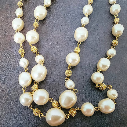 Faux pearl and gold tone beaded necklace.