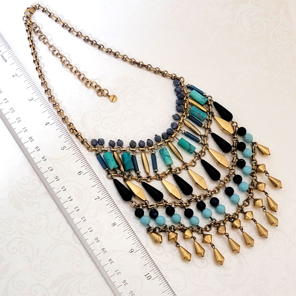 Big statement, tiered beaded, fringe necklace, by Stell and Dot, shown next to a ruler.