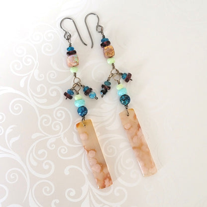 Very long multi gemstone dangle earrings, in peach and blue colors.