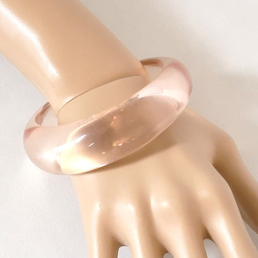 Clear acrylic bracelet on wrist.