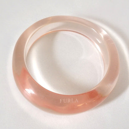 Clear pink plastic bracelet.