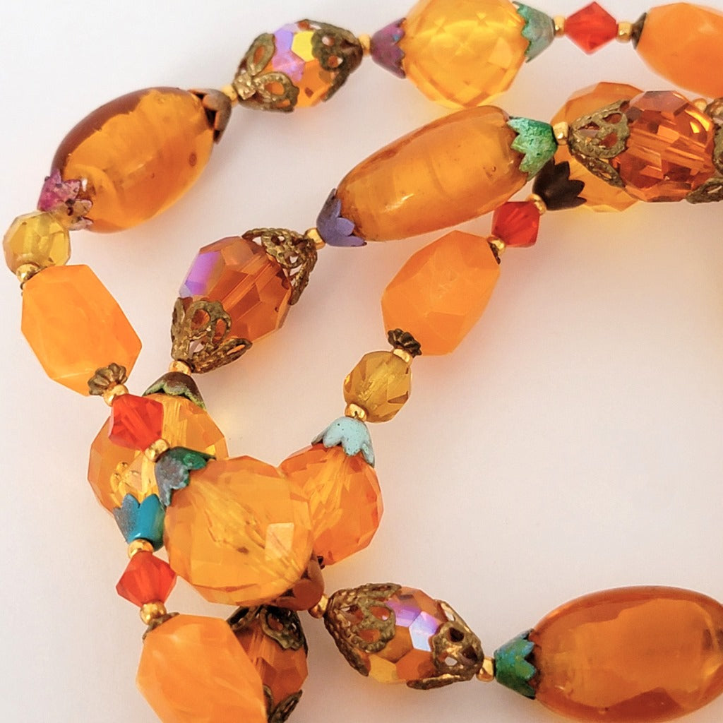 Orange beads and colorful bead caps.