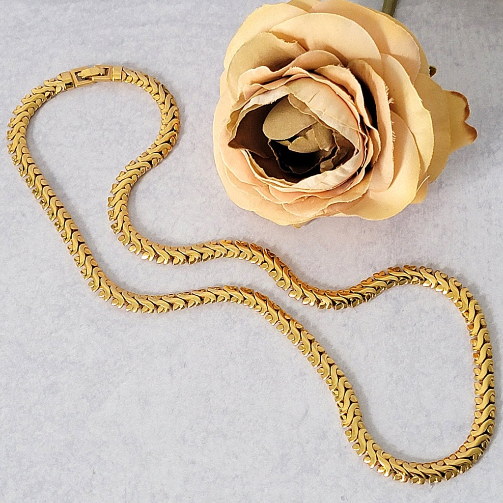 Long gold tone fancy chain necklace.