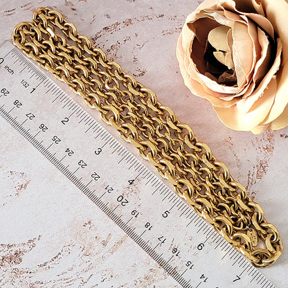 Gold chain necklace next to a ruler.