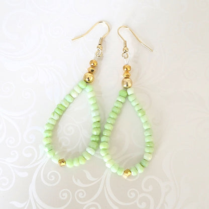 Green gemstone beaded dangle earrings, with gold crystal accents.