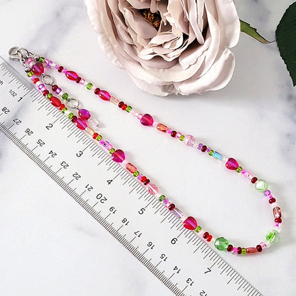 Beaded necklace next to a ruler.