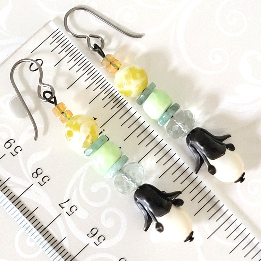 Floral drop dangle gemstone earrings, shown next to a ruler.