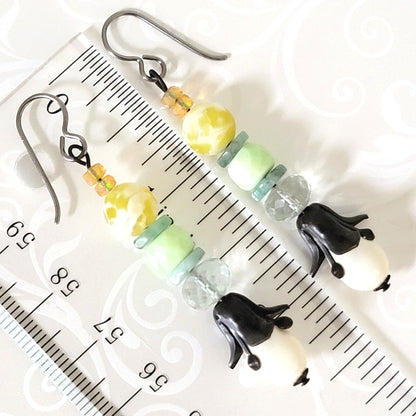 Floral drop dangle gemstone earrings, shown next to a ruler.