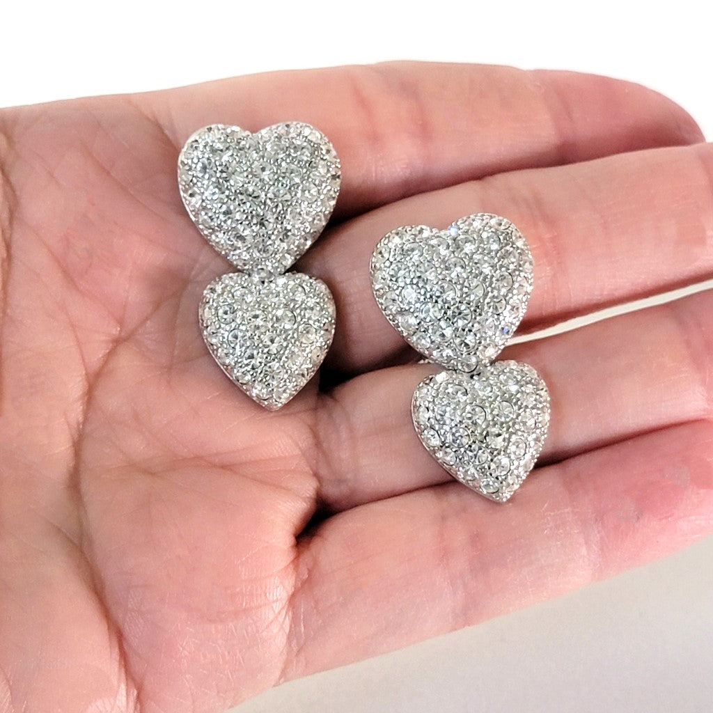 Heart earrings in hand.