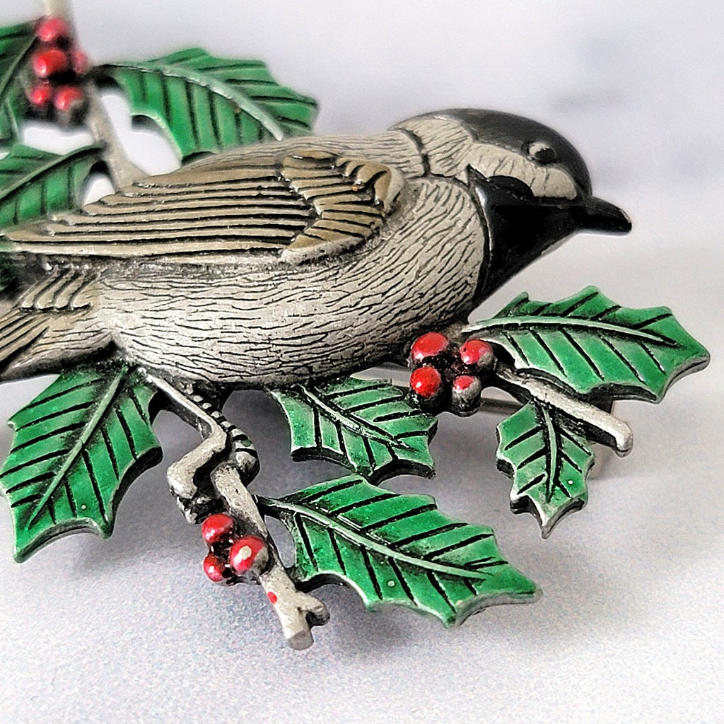 Green enamel on a bird brooch.