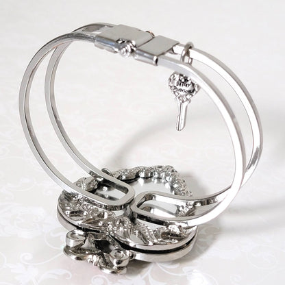 Inside view of a silver tone Betsey Johnson hinged clamper bracelet.