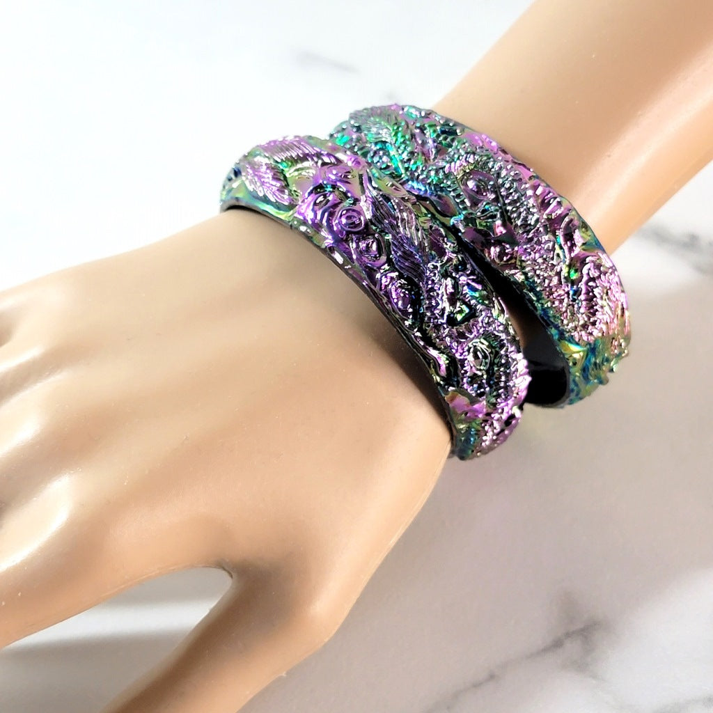 Iridescent bracelets on wrist.