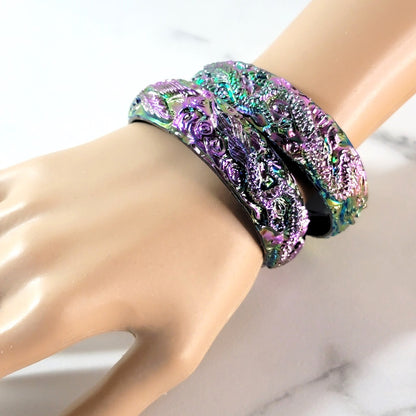 Iridescent bracelets on wrist.