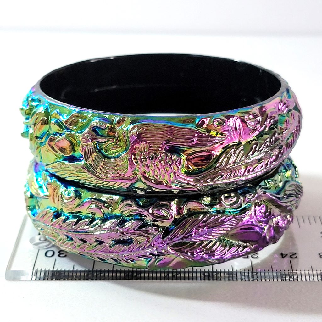 Plastic bangles on ruler.