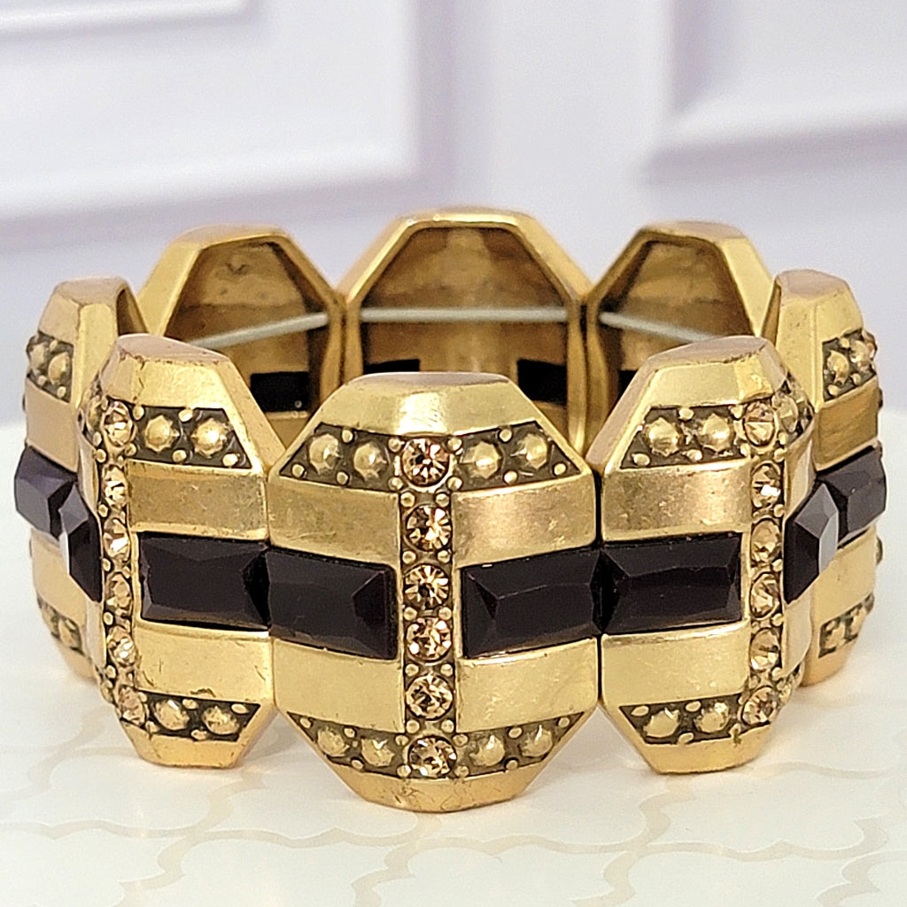 Geometric gold tone panels on a bracelet.