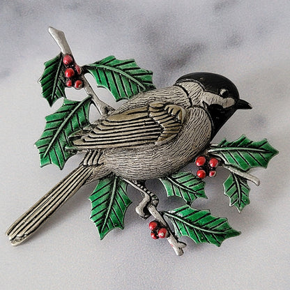 Chickadee brooch with holly leaves.