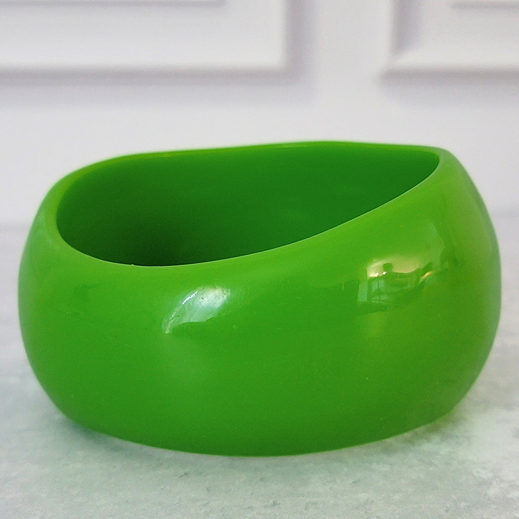 Large green acrylic bangle bracelet.