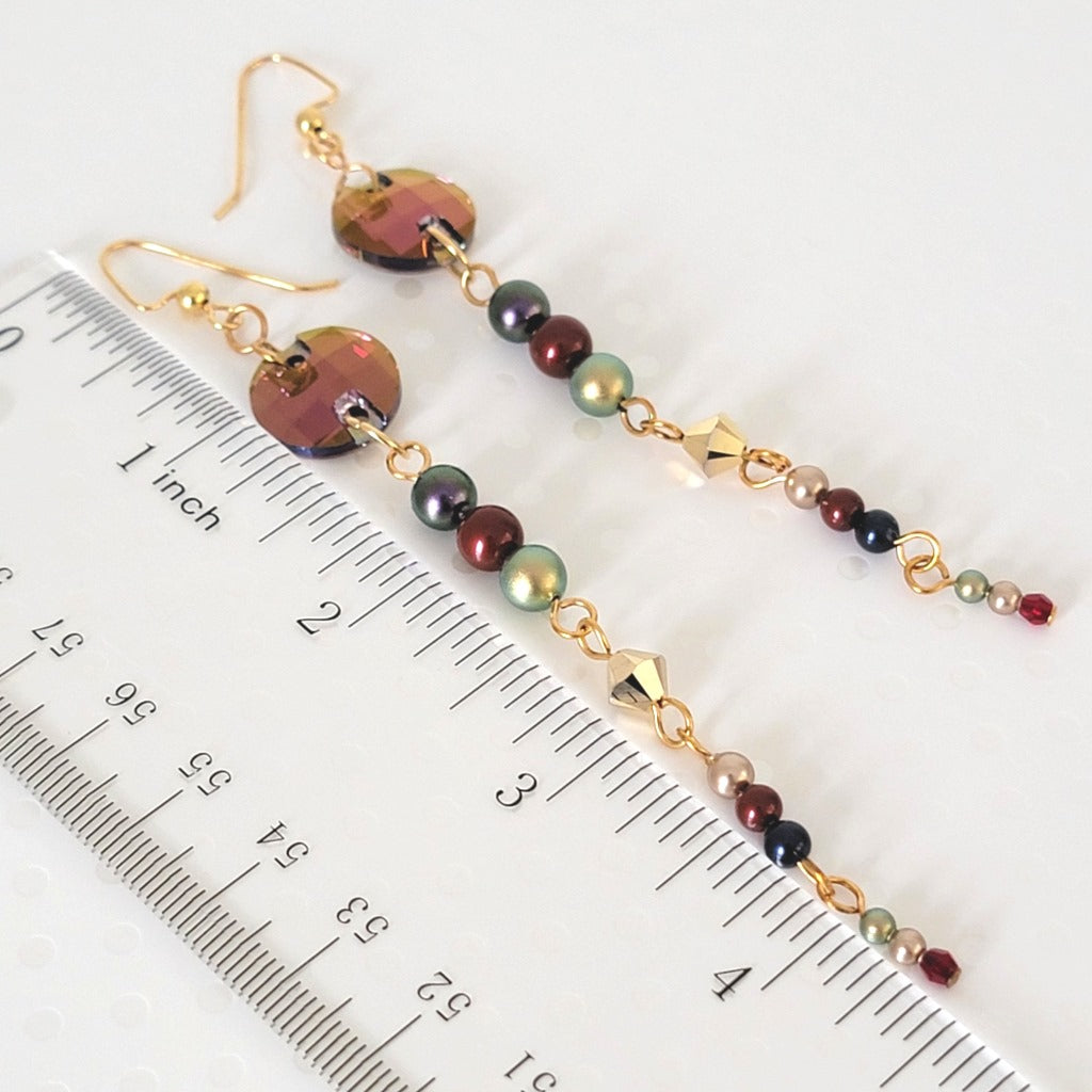 Shoulder grazing crystal earrings, shown next to a ruler.