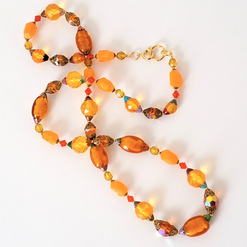 Long orange beaded necklace.