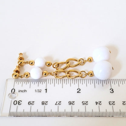 Long white earrings with ruler.