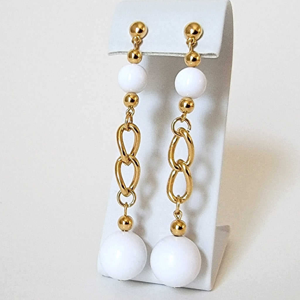 Long white beaded earrings.