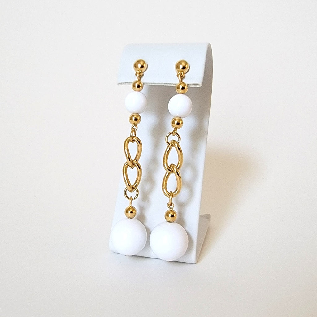 Long white dangle earrings.