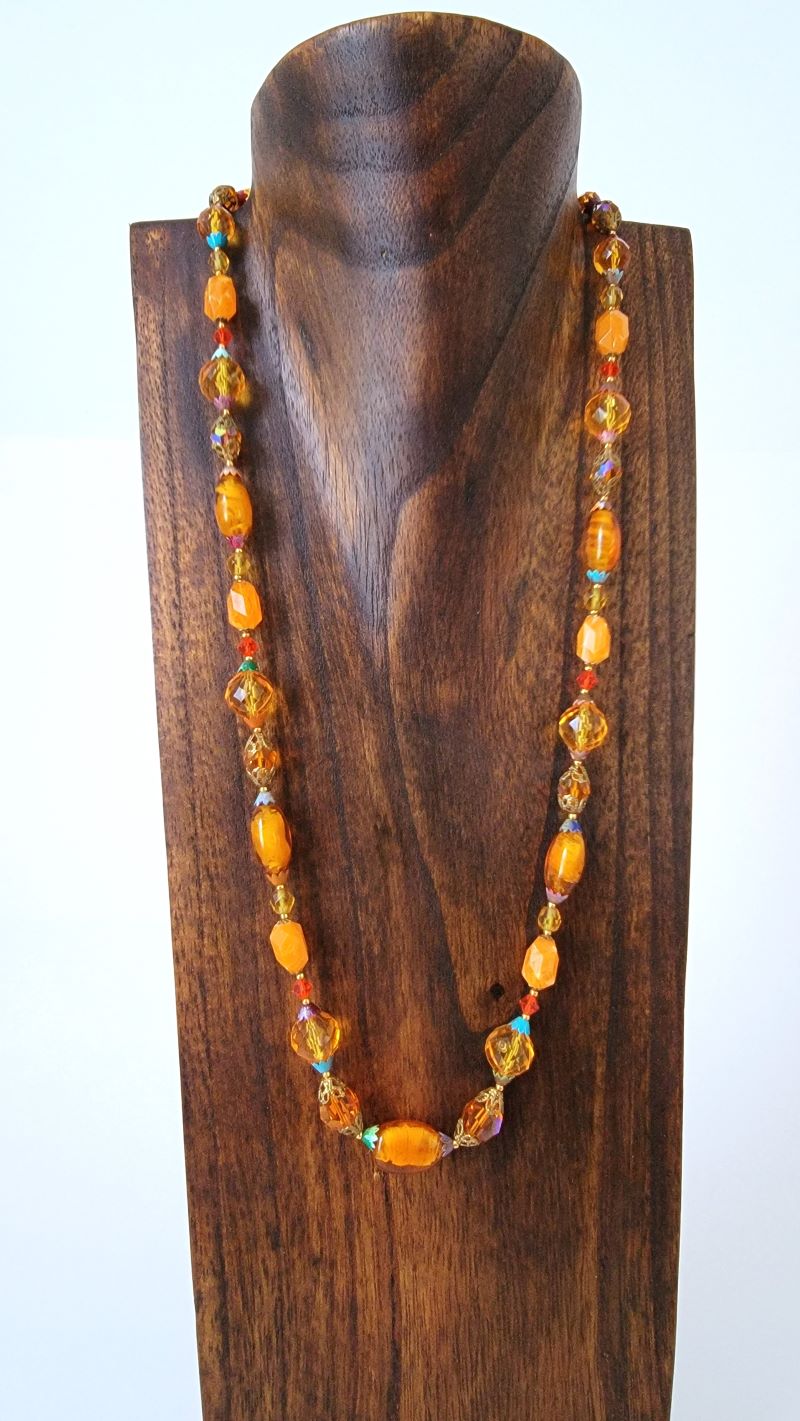 Long bead necklace on stand.