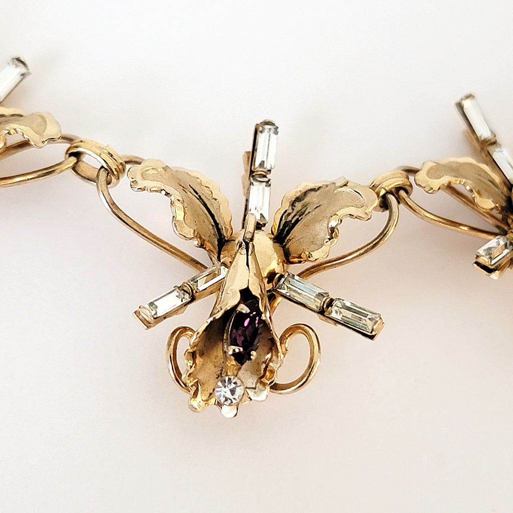 Middle rhinestone orchid necklace link.