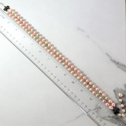 Faux pearl necklace with ruler.
