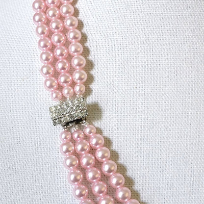 Rhinestone clasp on a pink faux pearl necklace.