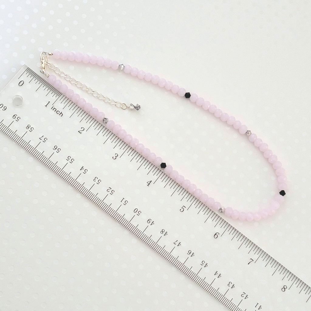 Minimalist pink glass beaded choker, shown next to a ruler.