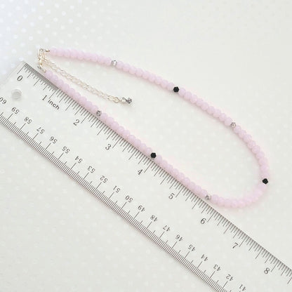 Minimalist pink glass beaded choker, shown next to a ruler.